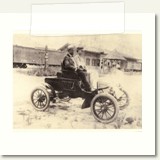 Dr. Sterling Gibon's Car 1903 (first car in Thomson). Picture taken at Main St and Jackson St., depot in background